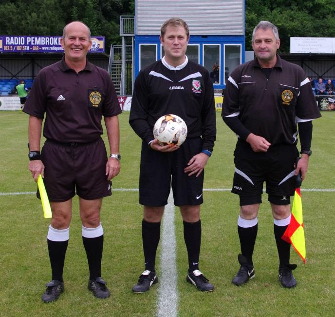 Officials Kevin Milich, James Olyott and Charles Davies