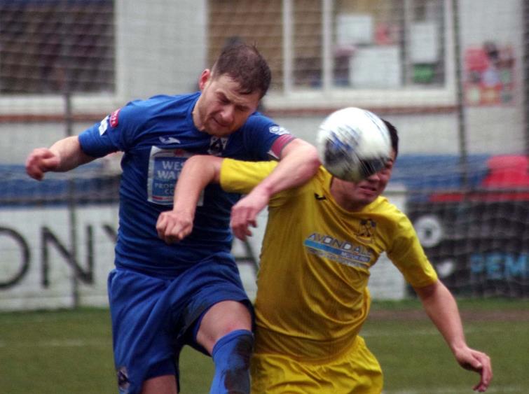 Haverfordwest County skipper Sean Pemberton wins this aerial dual