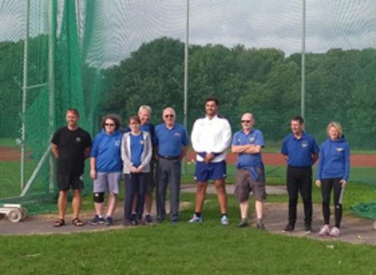 Pembrokeshire Harriers coaches join James in front of the newly refurbished cage