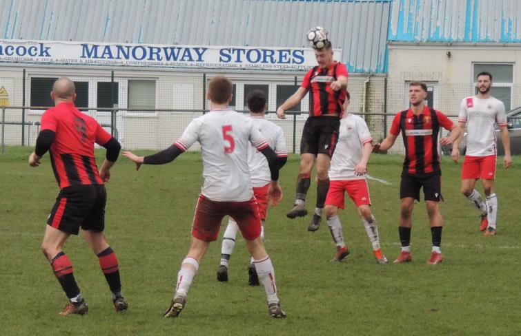 Heads you win - Rhys Jones clearly wins this aerial battle for Goodwick against Clarby Road. Picture Bill Carne