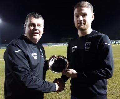 Haverfordwest County skipper Sean Pemberton receives a momento for his 200th game from manager Wayne Jones