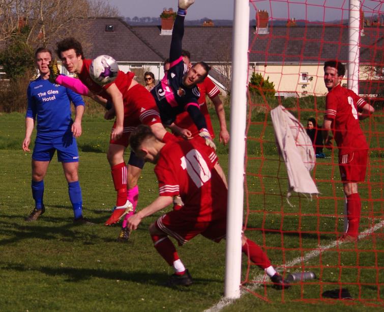 West Dragons clear the danger at a corner in their win over Merlins Bridge