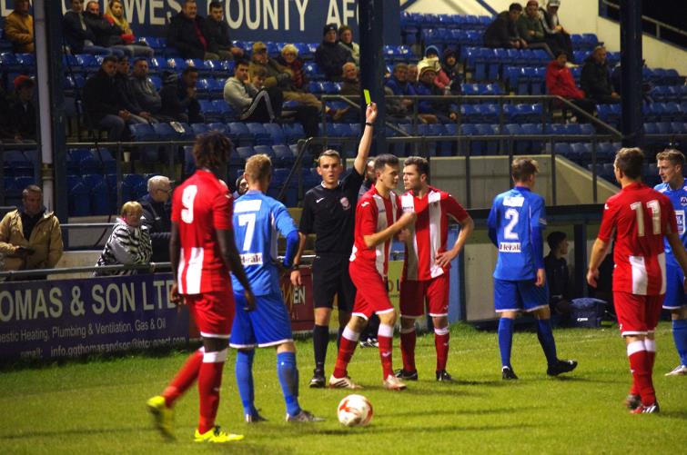 Referee B. Williams dishes out a yellow card in the clash between Haverfordwest County versus Afan Lido