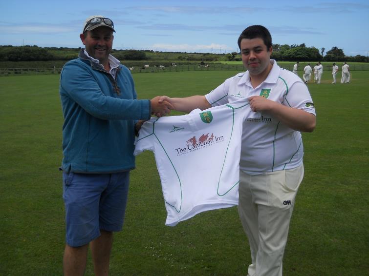 Jeremy Barton, of the Cambrian Inn, presents the new club shirts to Llanrhian Cricket Club captain Richard Reed.